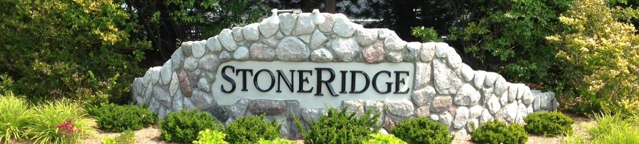 The stone StoneRidge sign at the neighborhood entrance